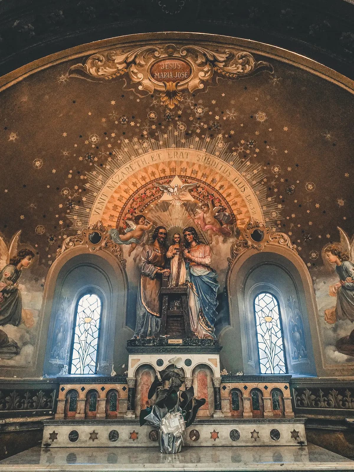 Church sanctuary interior with pews facing an altar