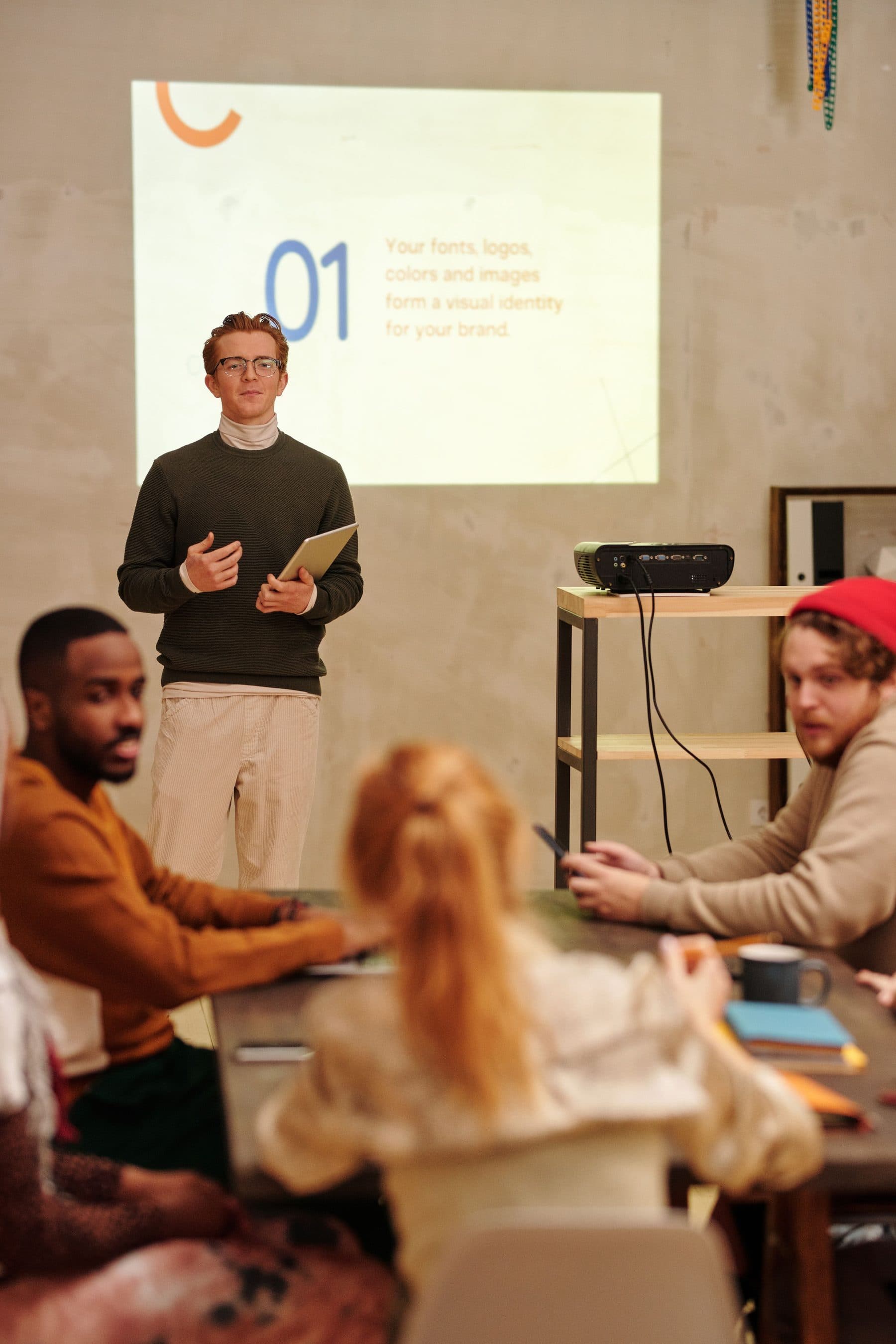 A presenter leading a small group through a training session in an office