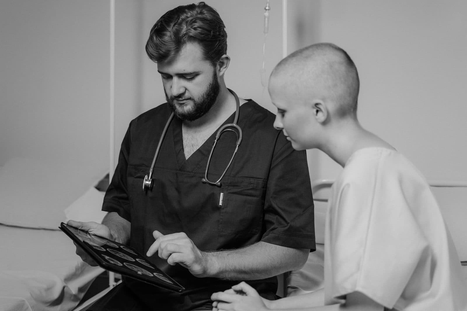A doctor and patient reviewing information together on a tablet